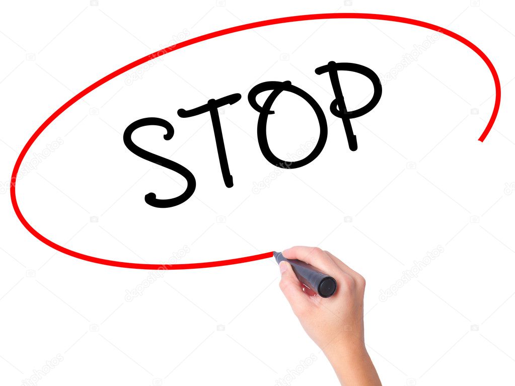 Women Hand writing STOP with black marker on visual screen.