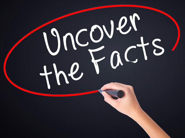 Woman Hand Writing Uncover the Facts with a marker over transpar