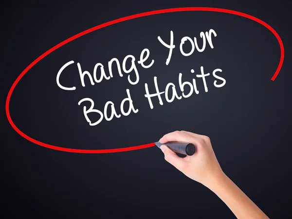 Woman Hand Writing Change Your Bad Habits  with a marker over tr
