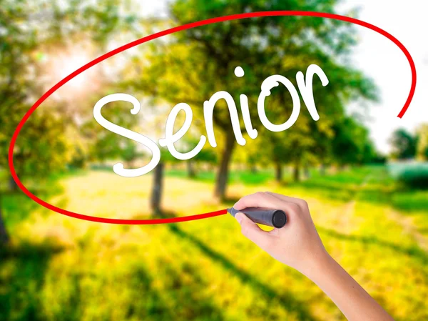 Woman Hand Writing Senior with a marker over transparent board — Stock Photo, Image