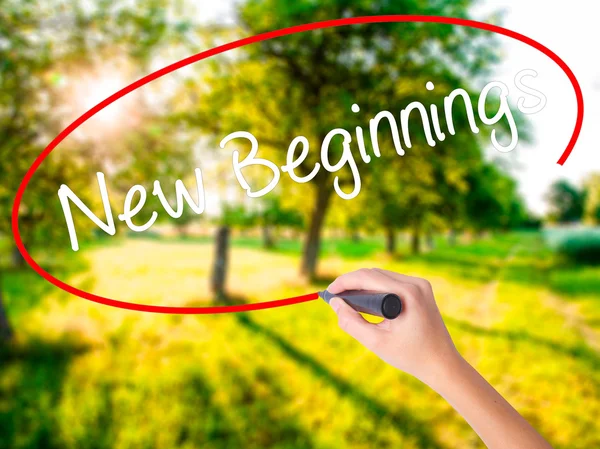 Woman Hand Writing New Beginnings with a marker over transparent — Stock Photo, Image