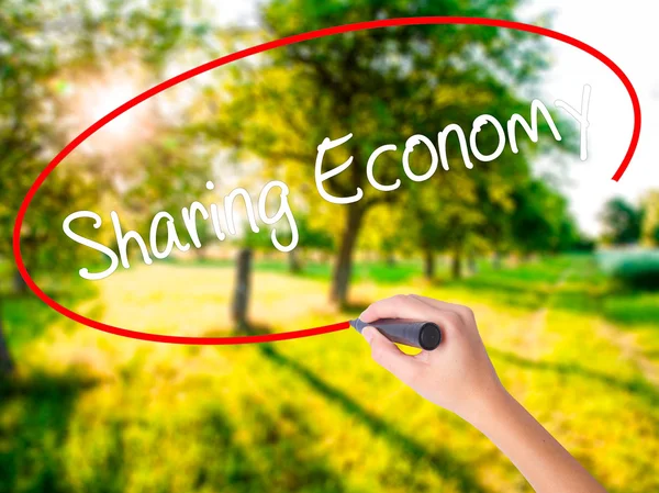 Woman Hand Writing Sharing Economy with a marker over transparen — Stock Photo, Image
