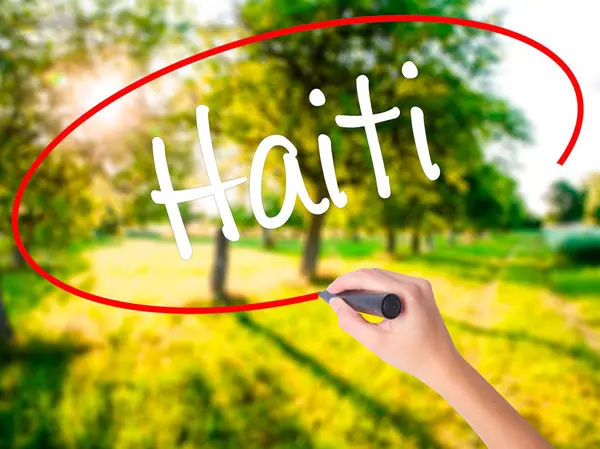 Woman Hand Writing Haiti with a marker over transparent board — Stock Photo, Image