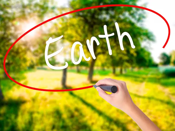 Woman Hand Writing Earth with a marker over transparent board . — Stock Photo, Image