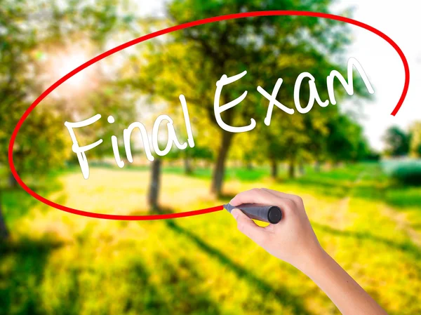 Woman Hand Writing Final Exam with a marker over transparent boa — Stock Photo, Image