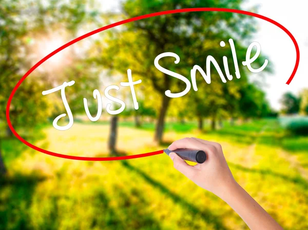 Woman Hand Writing Just Smile with a marker over transparent boa — Stock Photo, Image