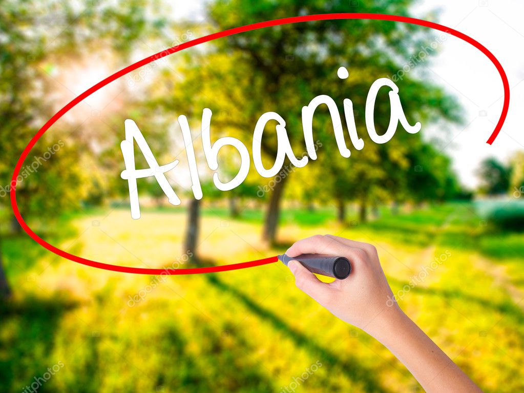 Woman Hand Writing Albania  with a marker over transparent board