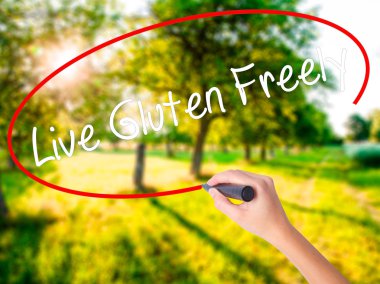 Woman Hand Writing Live Gluten Freely with a marker over transpa clipart