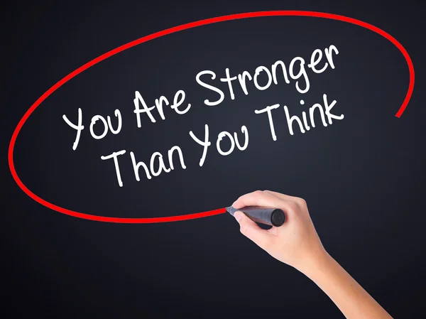 Woman Hand Writing You Are Stronger Than You Think with a marker