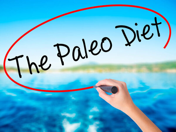 Woman Hand Writing The Paleo Diet with a marker over transparent