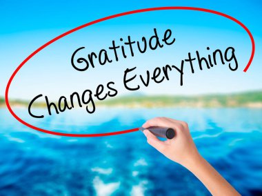 Woman Hand Writing Gratitude Changes Everything with a marker ov clipart
