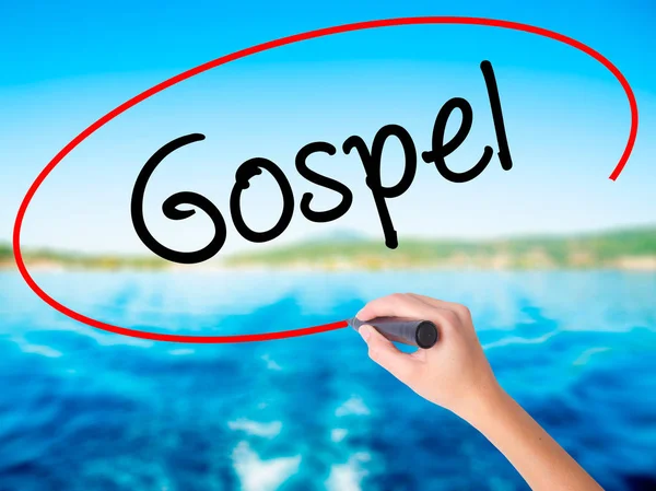 Woman Hand Writing Gospel  with a marker over transparent board — Stock Photo, Image
