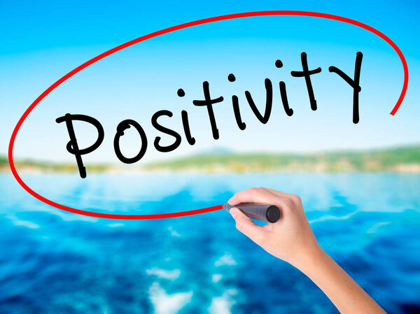 Woman Hand Writing Positivity with a marker over transparent boa