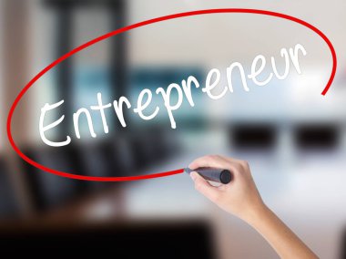 Woman Hand Writing Entrepreneur with a marker over transparent b clipart