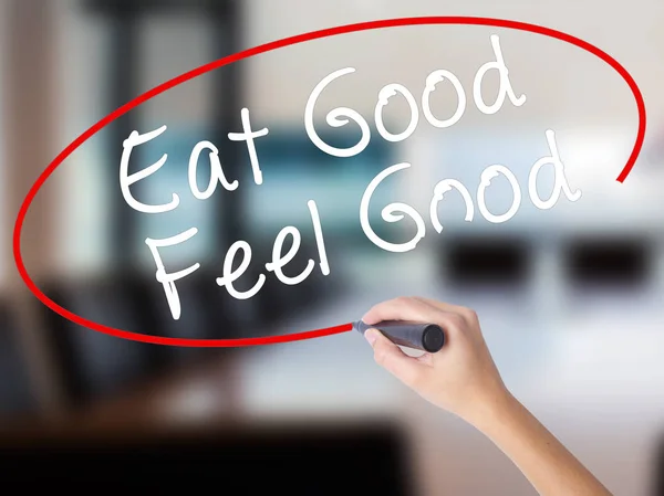 Woman Hand Writing Eat Good Feel Good with a marker over transpa