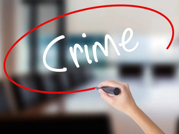 Woman Hand Writing Crime with a marker over transparent board — Stock Photo, Image