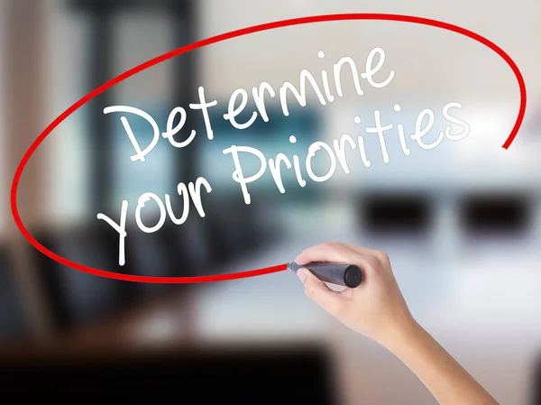 Woman Hand Writing Determine your Priorities with a marker over — Stock Photo, Image
