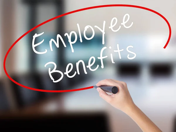 Woman Hand Writing Employee Benefits with a marker over transpar