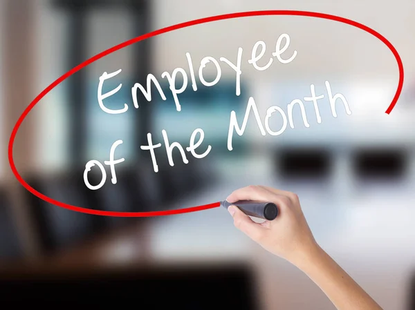 Woman Hand Writing Employee of the Month  with a marker over tra