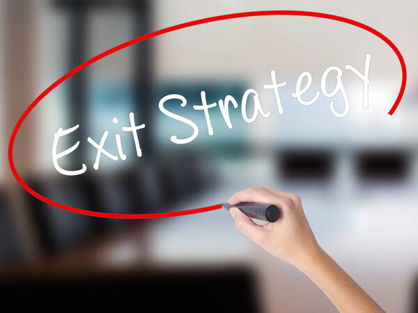 Woman Hand Writing Exit Strategy with a marker over transparent 