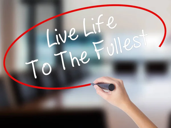 Woman Hand Writing Live Life To The Fullest with a marker over t
