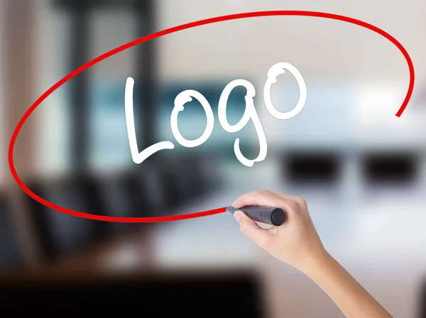 Woman Hand Writing Logo  with a marker over transparent board