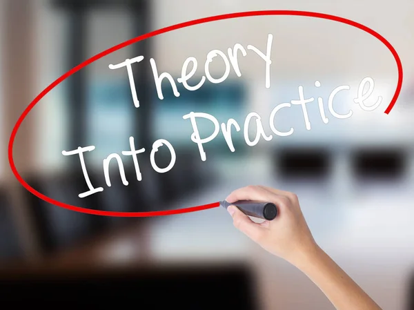 Woman Hand Writing Theory Into Practice with a marker over trans — Stock Photo, Image