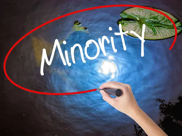 Woman Hand Writing Minority with marker over transparent board — Stock Photo, Image