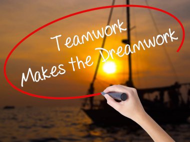 Woman Hand Writing Teamwork Makes the Dreamwork with a marker ov clipart
