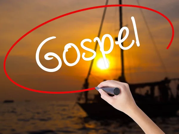 Woman Hand Writing Gospel  with a marker over transparent board — Stock Photo, Image