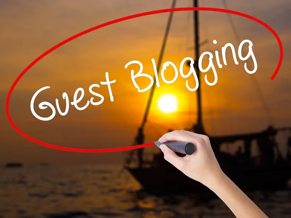 Woman Hand Writing Guest Blogging  with a marker over transparen — Stock Photo, Image