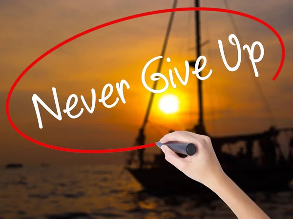 Woman Hand Writing Never Give Up with a marker over transparent — Stock Photo, Image