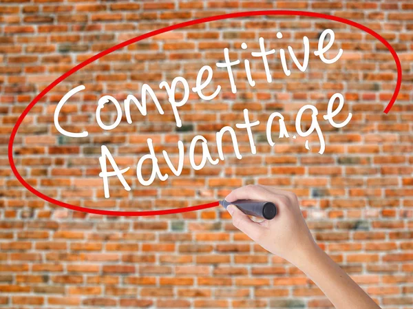 Woman Hand Writing Competitive Advantage with black marker on vi