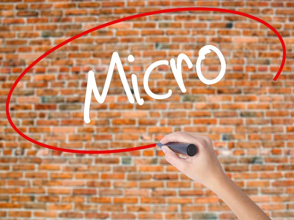 Woman Hand Writing Scope with a marker over transparent board