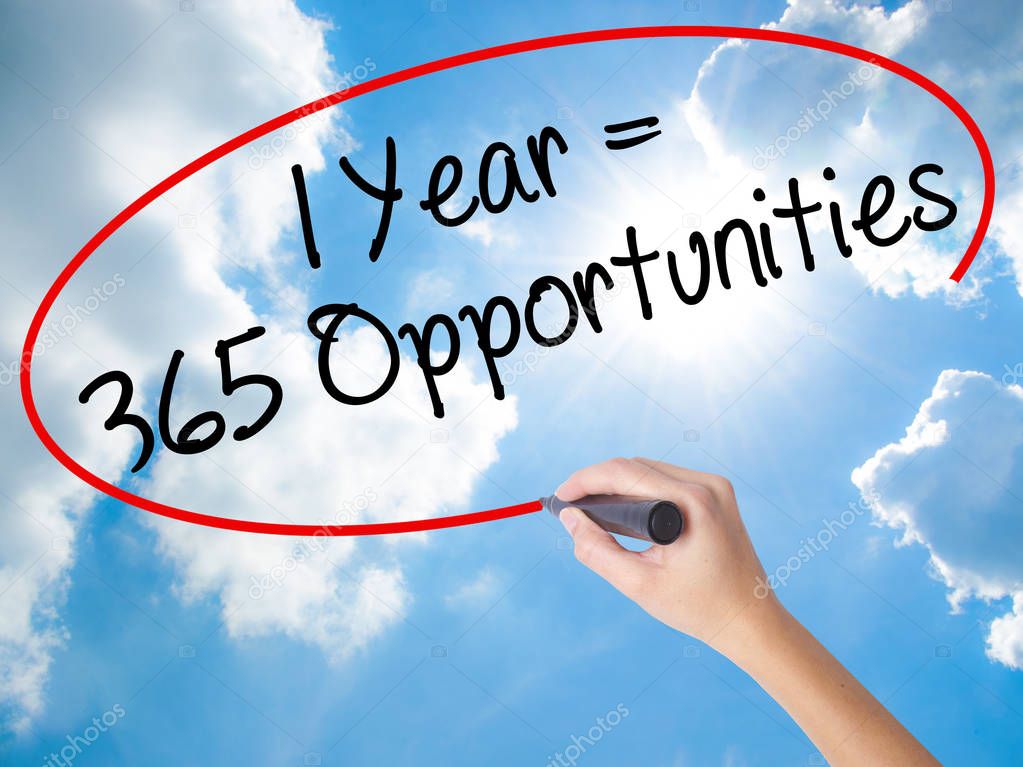 Woman Hand Writing 1 Year  365 Opportunities with black marker 