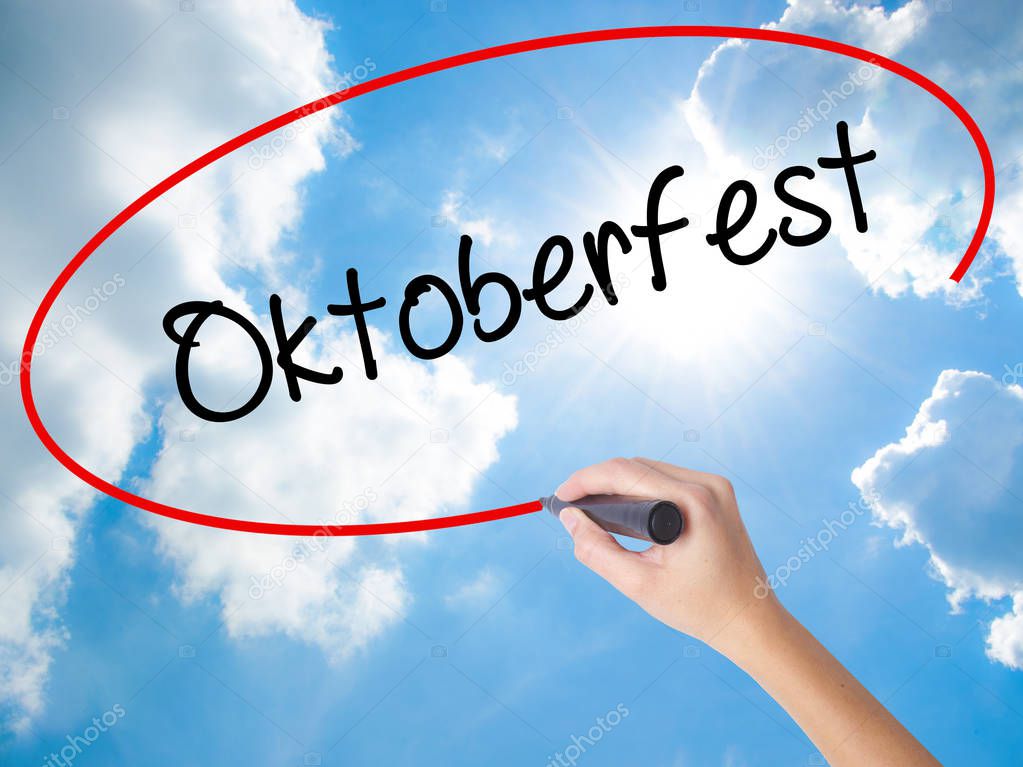 Woman Hand Writing Oktoberfest with black marker on visual scree