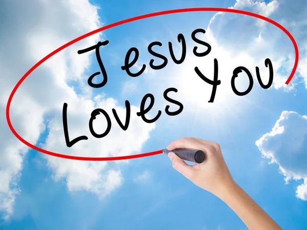 Woman Hand Writing Jesus Loves You with black marker on visual s