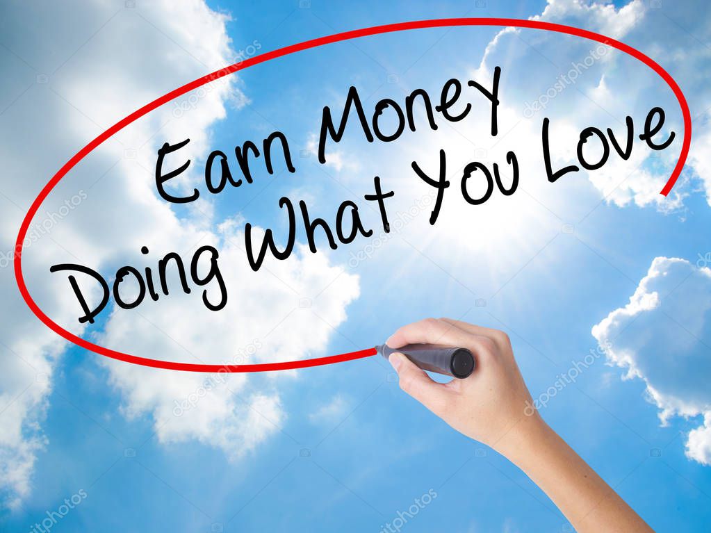 Woman Hand Writing Earn Money Doing What You Love with black mar