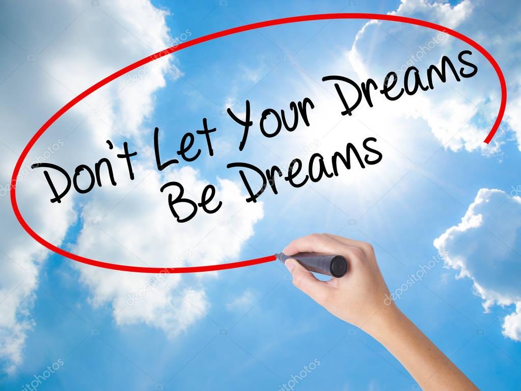 Woman Hand Writing Don't Let Your Dreams Be Dreams with black ma