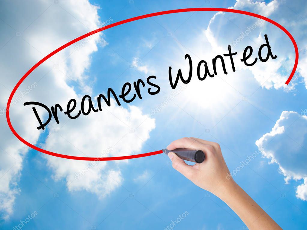 Woman Hand Writing Dreamers Wanted  with black marker on visual 