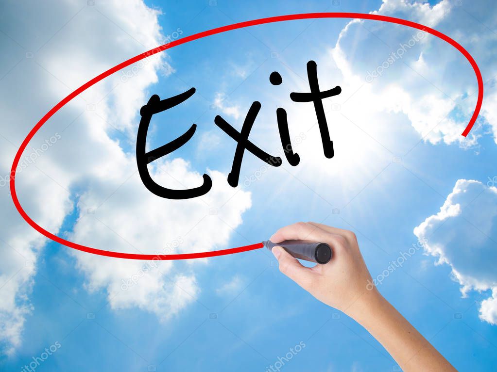 Woman Hand Writing Exit with black marker on visual screen