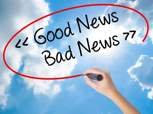 Woman Hand Writing Good News - Bad News with black marker on vis