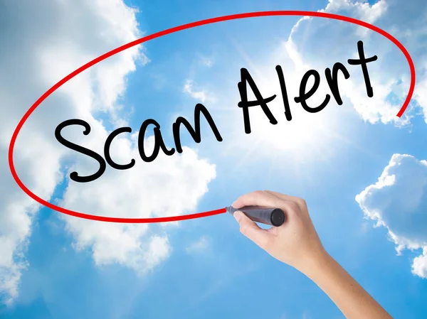 Woman Hand Writing Scam Alert  with black marker on visual scree — Stock Photo, Image