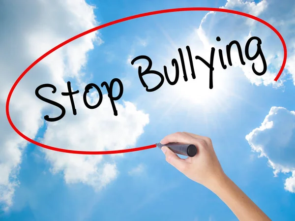 Woman Hand Writing Stop Bullying with black marker on visual scr