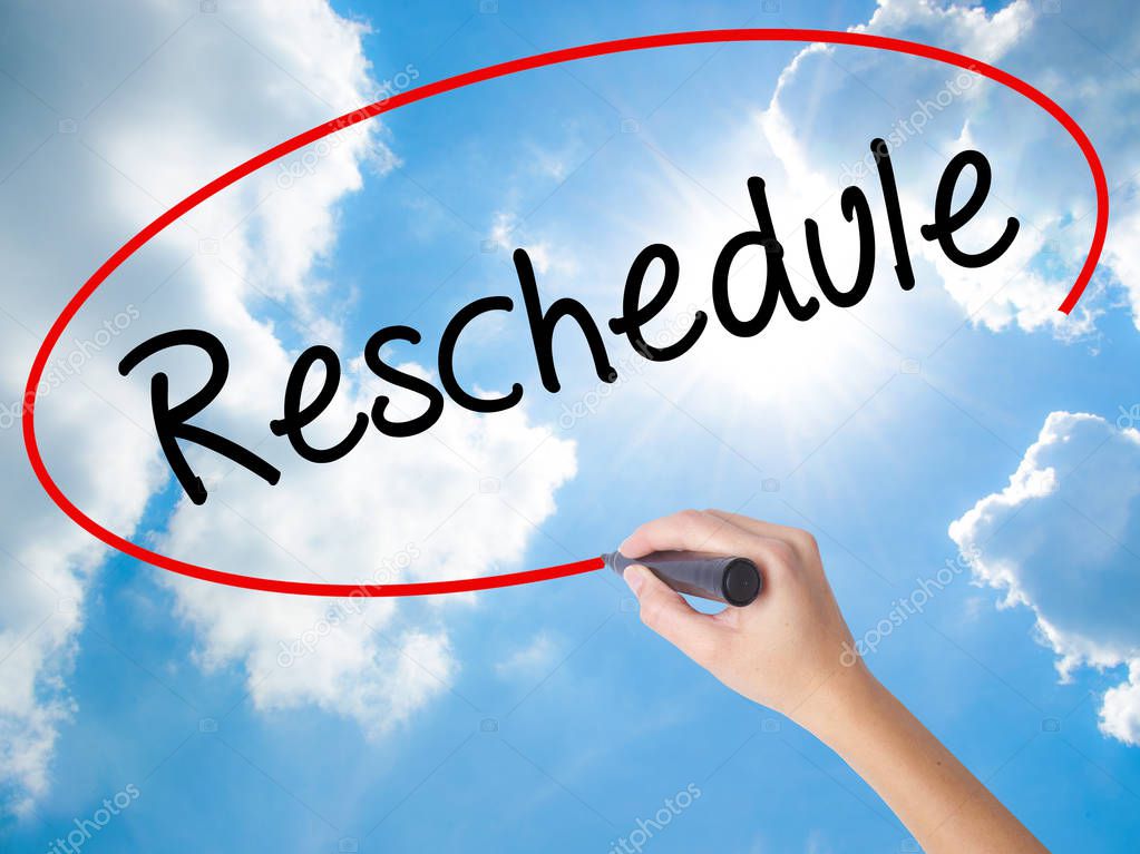 Woman Hand Writing Reschedule  with black marker on visual scree