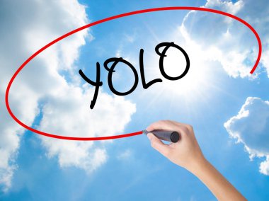 Woman Hand Writing YOLO (You Only Live Once) with black marker o clipart