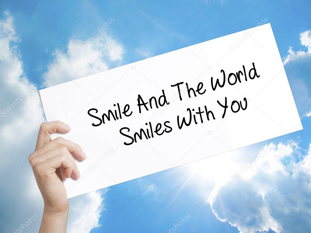 Man Hand Holding Paper with text Smile And The World Smiles To Y