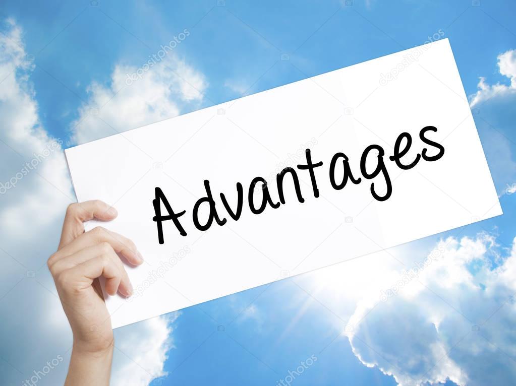 Advantages Sign on white paper. Man Hand Holding Paper with text