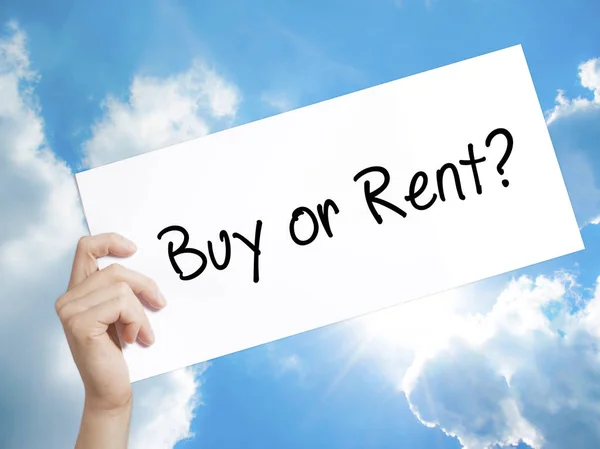 Buy or Rent? Sign on white paper. Man Hand Holding Paper with te
