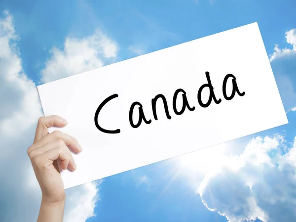 Καναδά σύμβολο σε λευκό χαρτί. Άνθρωπος χέρι κρατά χαρτί με το κείμενο. Είναι — Φωτογραφία Αρχείου